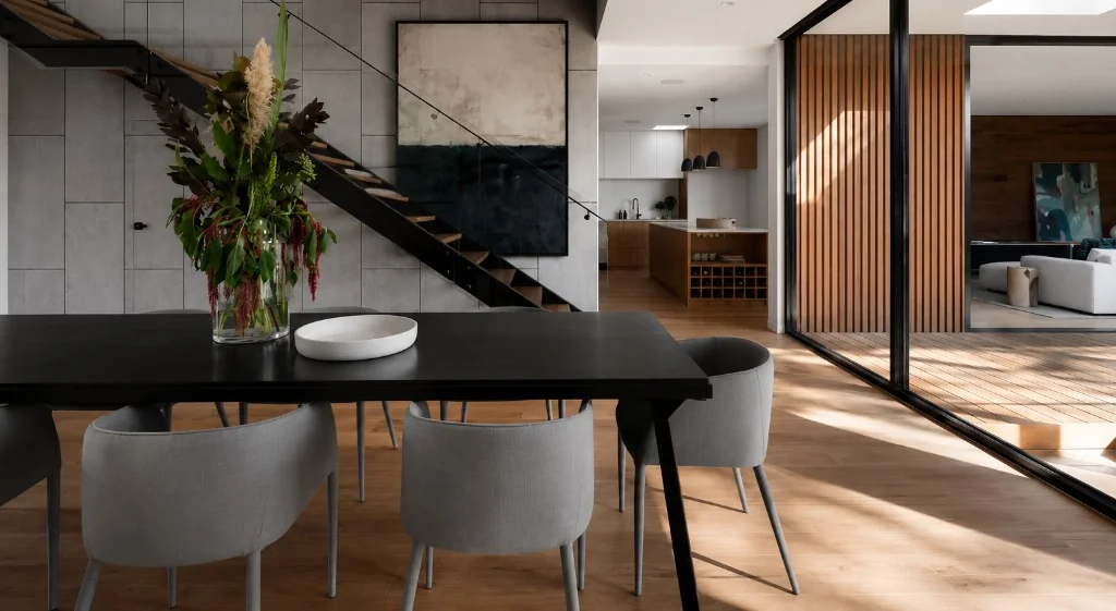 Modern open-plan dining and living space with curated artwork